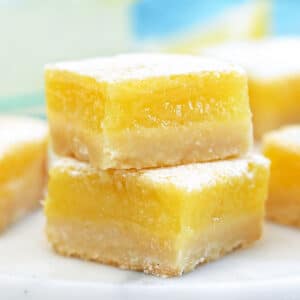 Close up of two square lemon bars.