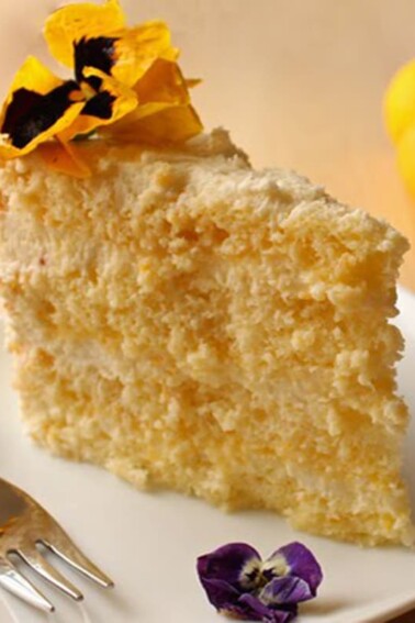 Slice of Lemon-Mascarpone Layer Cake on a white plate.
