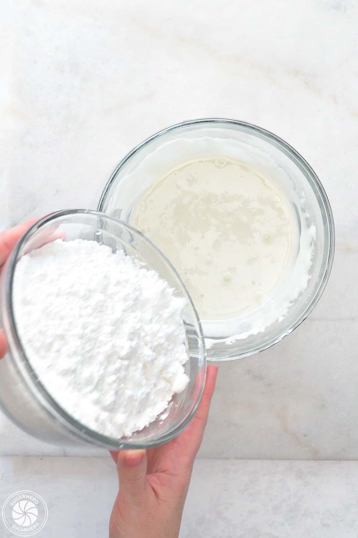 Pouring powdered sugar into melted marshmallows.