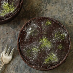 Matcha Chocolate Tart on a marble countertop next to a silver fork.