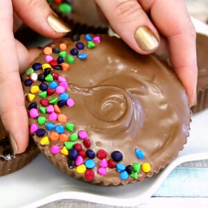 Hands displaying a Mega Stuffed Peanut Butter Cup.