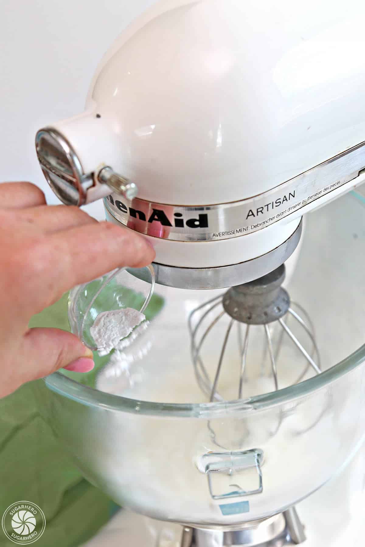 Adding cream of tartar to whipped egg whites.