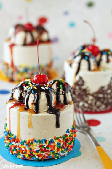Three mini banana split cakes with cherries on top