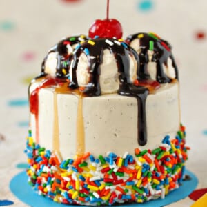 Close up of a Mini Banana Split Cake on a light blue surface.