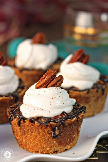 Close up of Mini Pecan Pie with whipped cream on top.