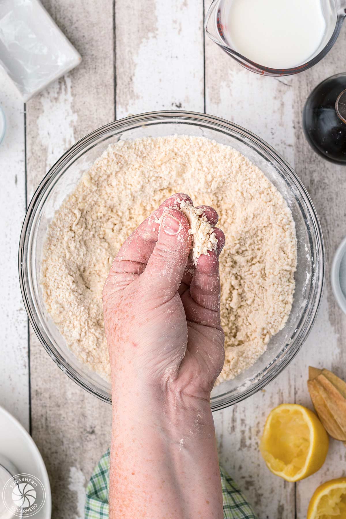 Hand holding up the cobbler topping to show texture.