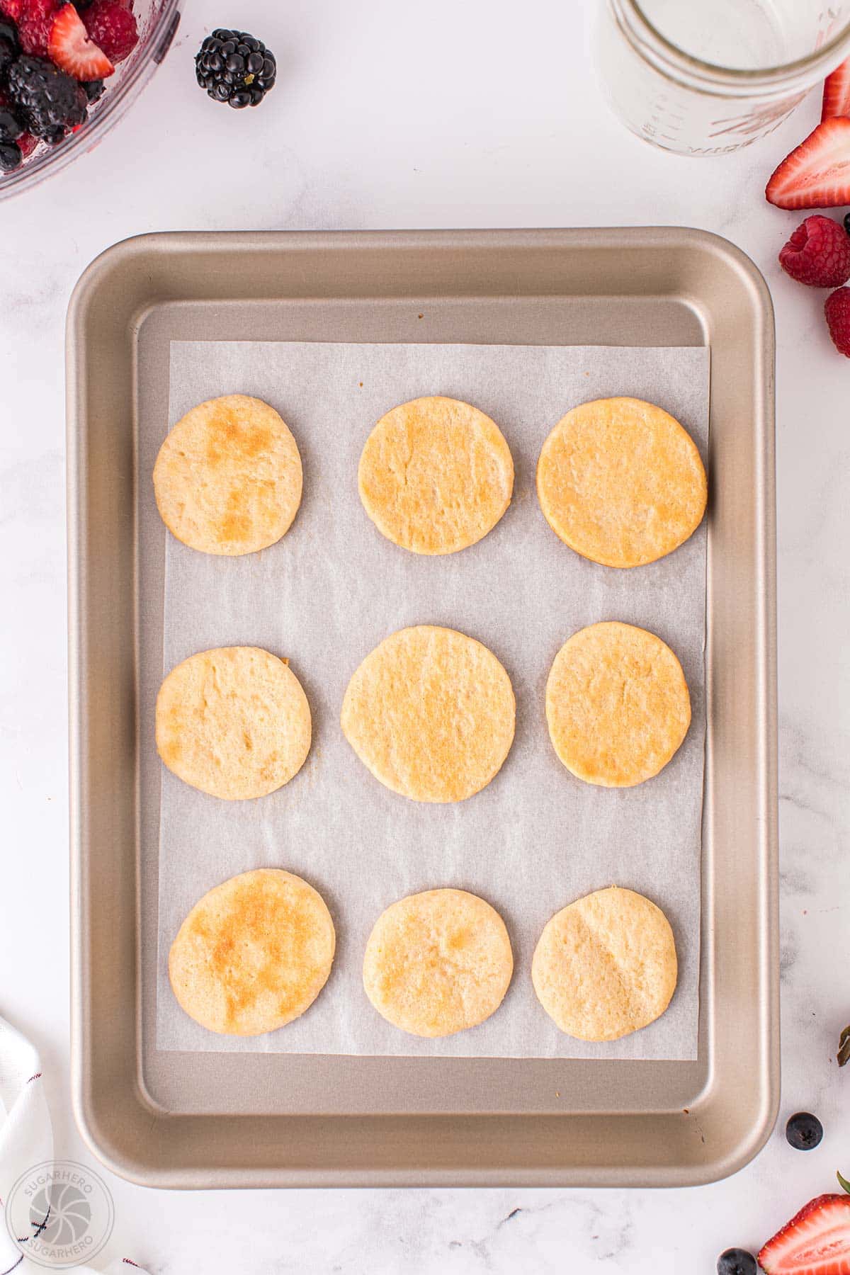 Baked crescent roll circles on a baking sheet.