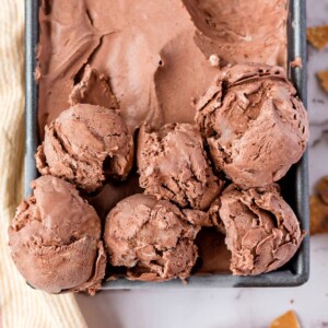 Close up of 6 scoops of No-Churn Chocolate Ice Cream in a silver container.