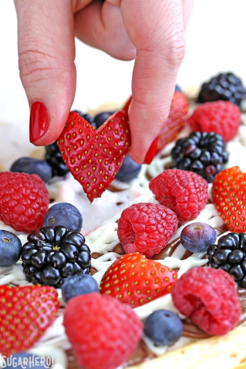 Nutella Puff Pastry Pizza is easy and gourmet. You&rsquo;ll love the combination of buttery puff pastry, Nutella, white chocolate, and juicy fresh berries! | From SugarHero.com