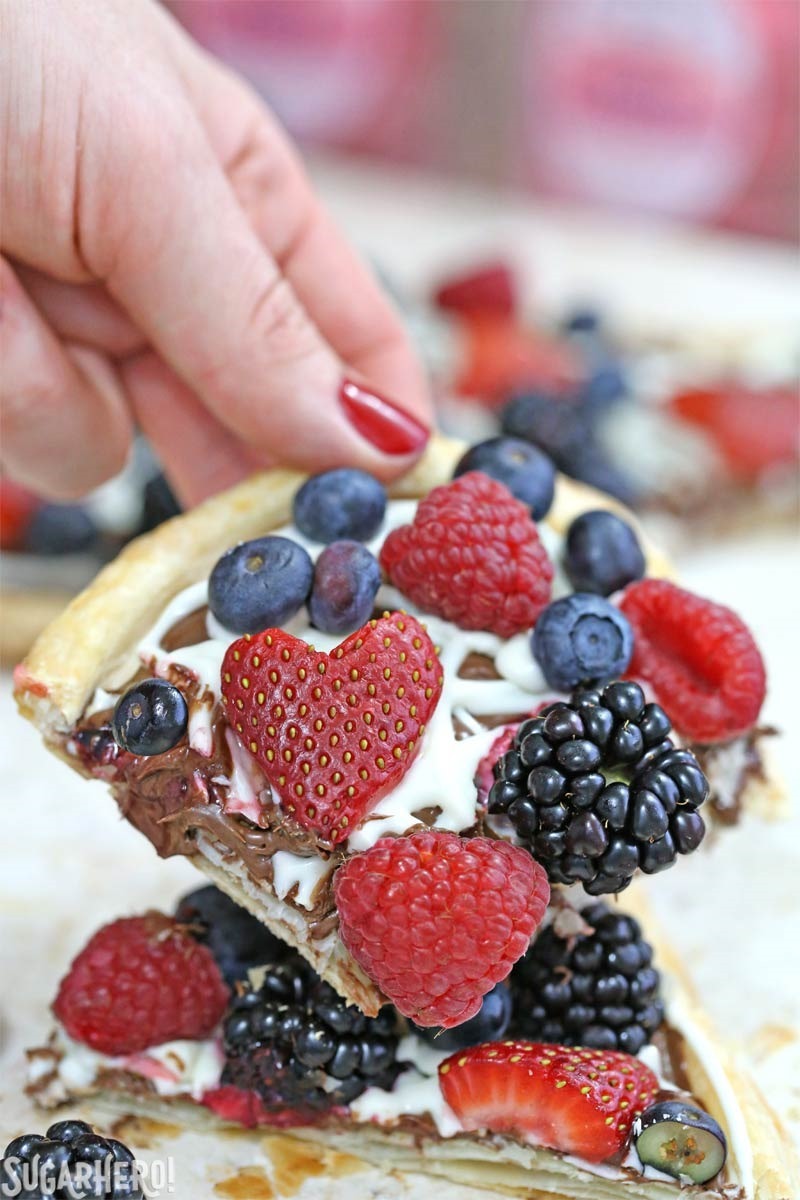 Nutella Puff Pastry Pizza is easy and gourmet. You&rsquo;ll love the combination of buttery puff pastry, Nutella, white chocolate, and juicy fresh berries! | From SugarHero.com