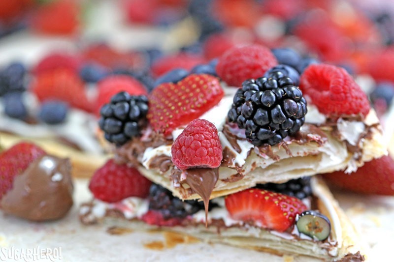 Nutella Puff Pastry Pizza is easy and gourmet. You&rsquo;ll love the combination of buttery puff pastry, Nutella, white chocolate, and juicy fresh berries! | From SugarHero.com