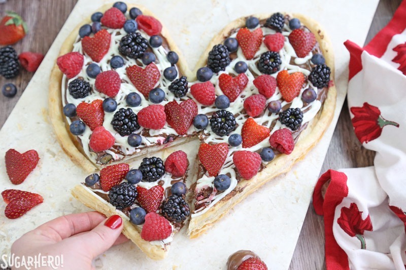 Nutella Puff Pastry Pizza is easy and gourmet. You&rsquo;ll love the combination of buttery puff pastry, Nutella, white chocolate, and juicy fresh berries! | From SugarHero.com