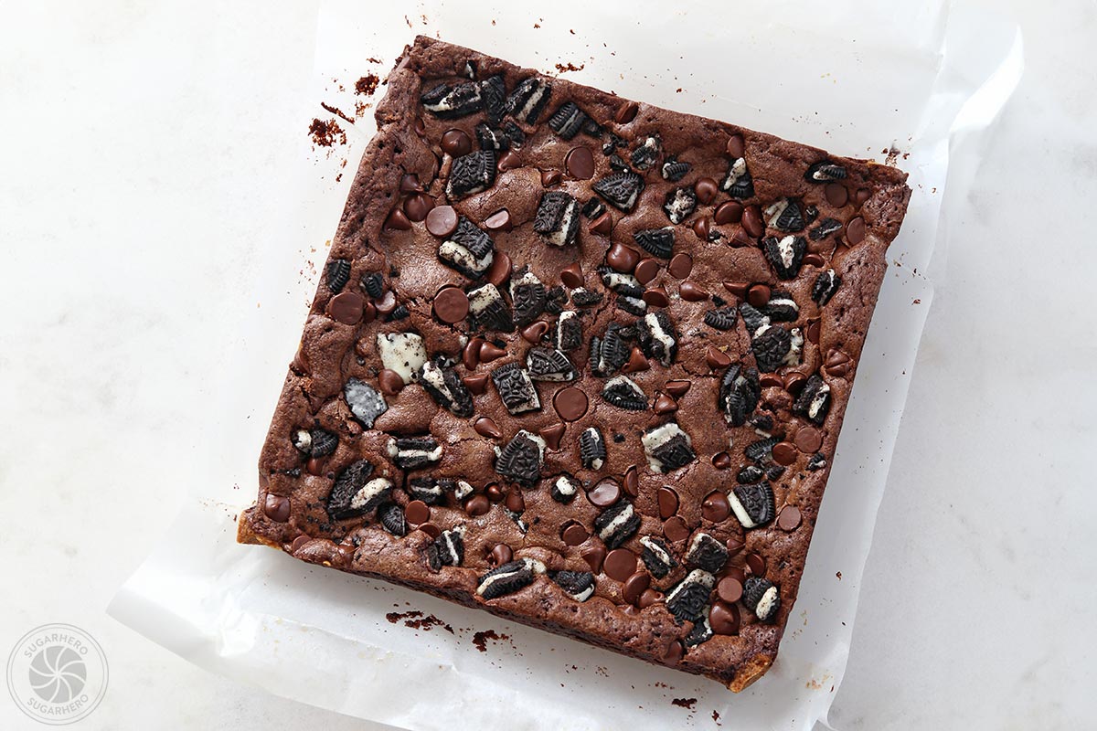 Block of uncut cookie bars on white parchment.