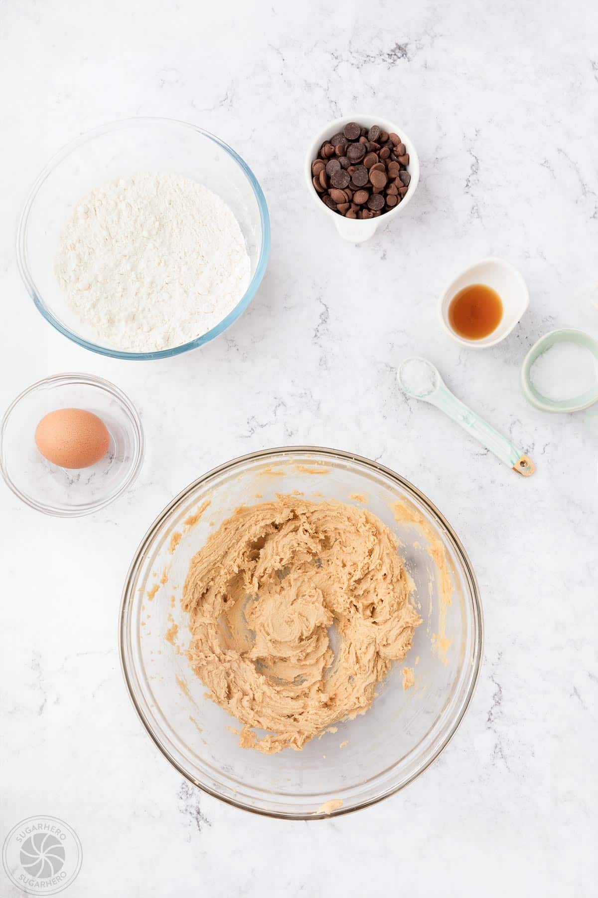 Mixing eggs and brown sugar to make chocolate chip cookie dough.