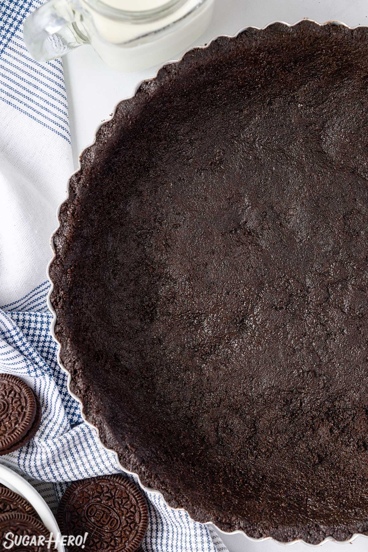 Top view of half of an Oreo Pie Crust in a silver pie pan.