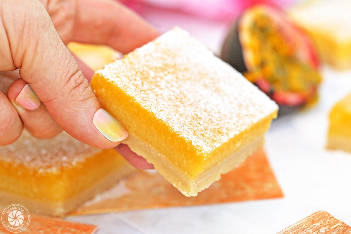 Close up of Passion Fruit Bar held by a hand.