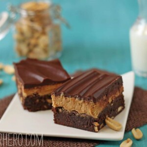 2 Layered Peanut Butter Brownies on a square white plate.