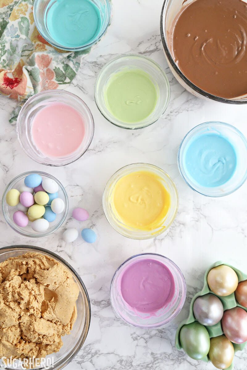 Overhead shot of melted pastel candy coating on a white marble surface