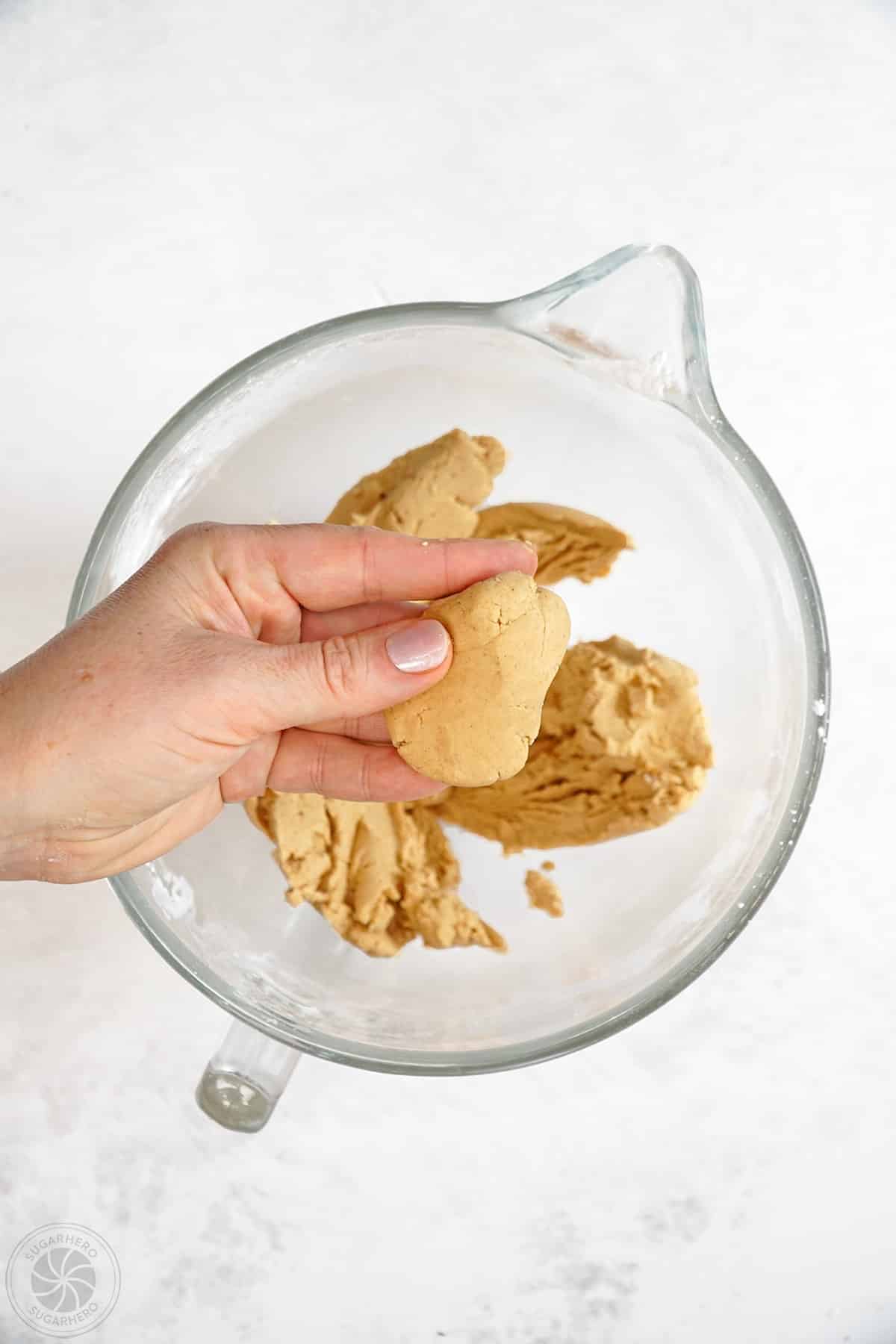 Hand showing firm texture of peanut butter filling.