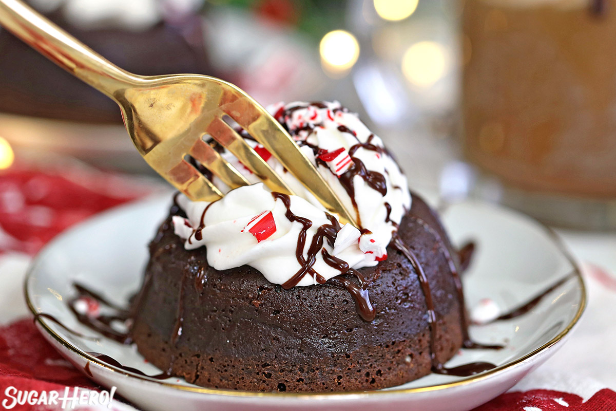 Gold fork taking a bite out of Peppermint Lava Cake.