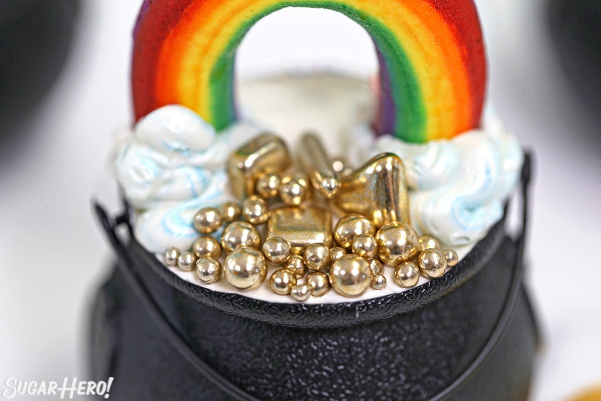 Close-up of metallic gold sprinkles on top of cupcake cups.