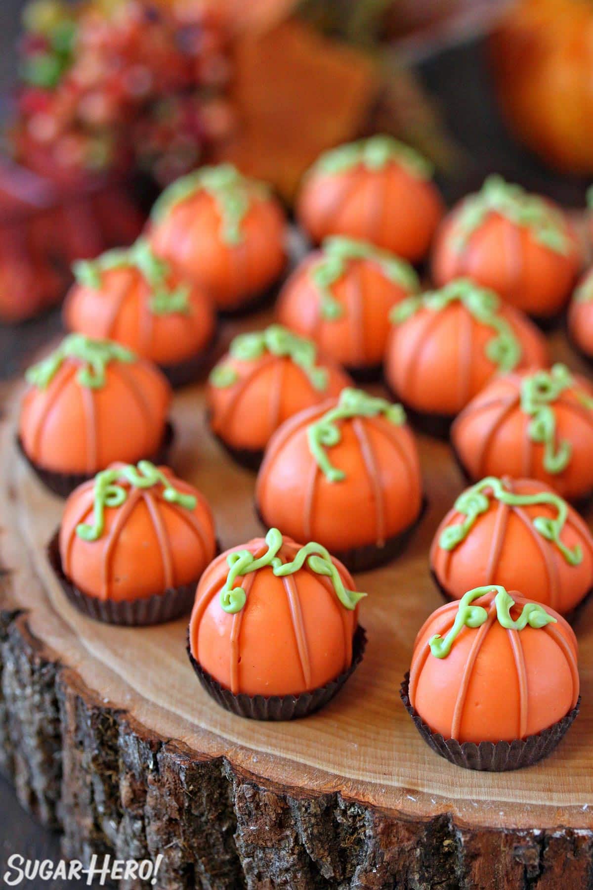 Pumpkin Bread Truffles on a wooden tree slice serving plate.