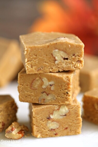 3 pieces of Pumpkin Fudge stacked one on top of the other.