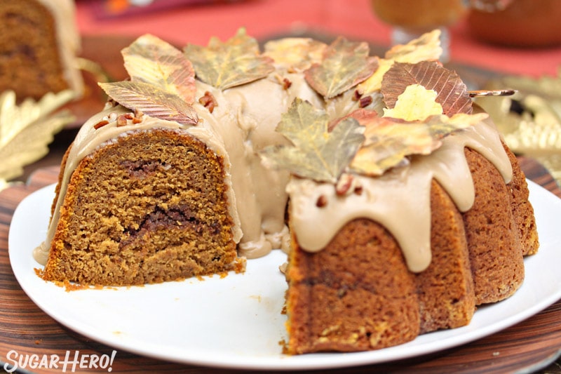 Pumpkin Pound Cake on a white platter with several pieces taken out.
