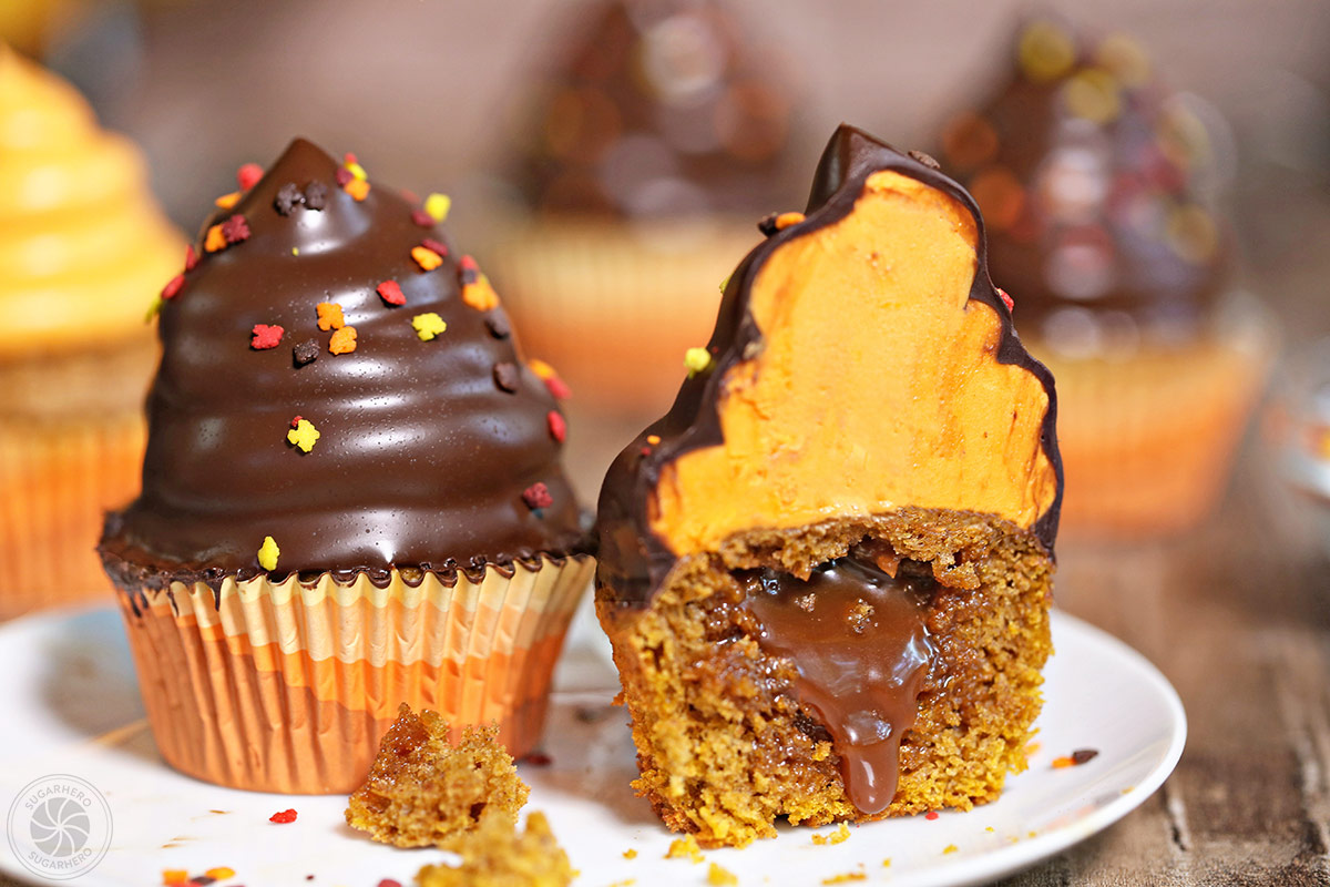 2 Pumpkin Spice Hi-Hat Cupcakes on a white plate with the 2nd muffin cut in half to show layers and texture.