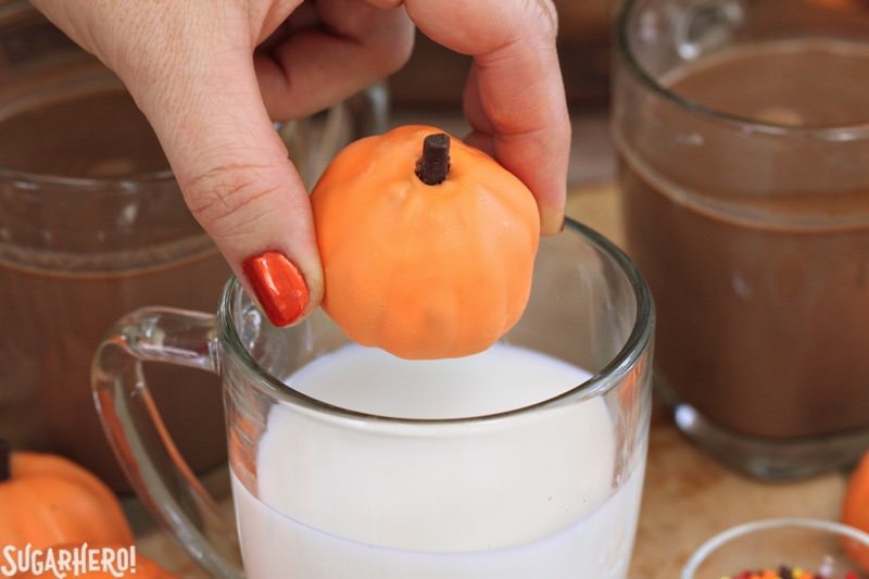 Pumpkin Spice Hot Chocolate Truffles - adding a pumpkin spice truffle to a mug of warm milk to make pumpkin spice hot chocolate | From SugarHero.com