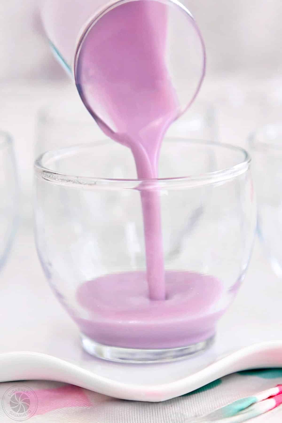 Pouring creamy gelatin into a dessert glass.