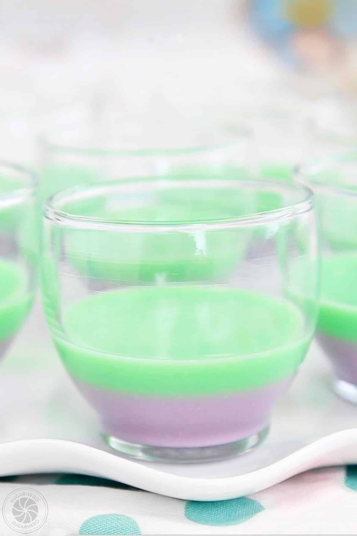 A dessert glass with two layers of colorful gelatin.