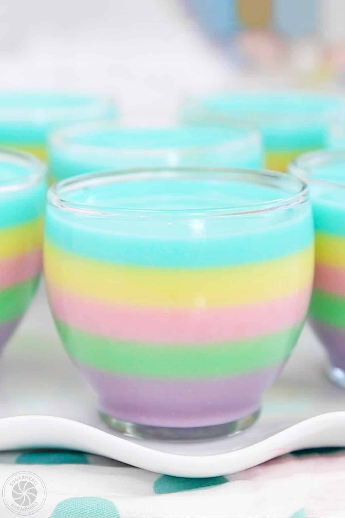 Close up of a rainbow gelatin cup on a tray.