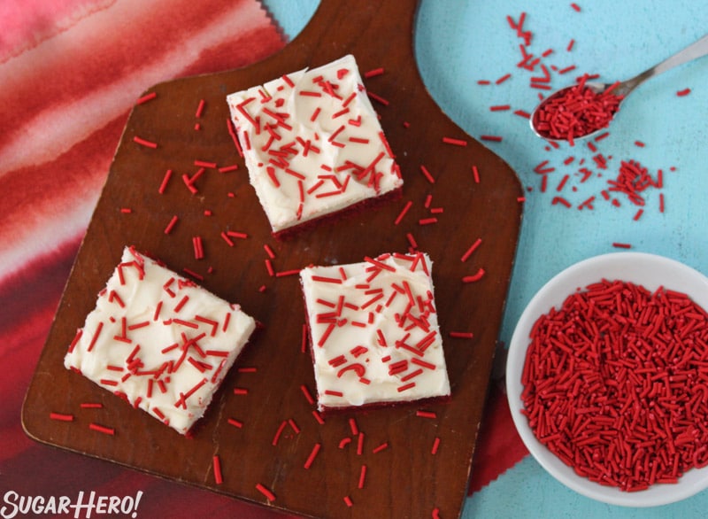 Red Velvet Bars - Three separate Red Velvet Bars with red homemade sprinkles. | From SugarHero.com 