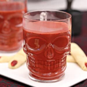 Clear skull-shaped mug full of red velvet hot chocolate.