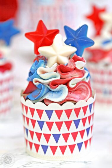 A Red, White and Blue Cupcake with candy stars on top.