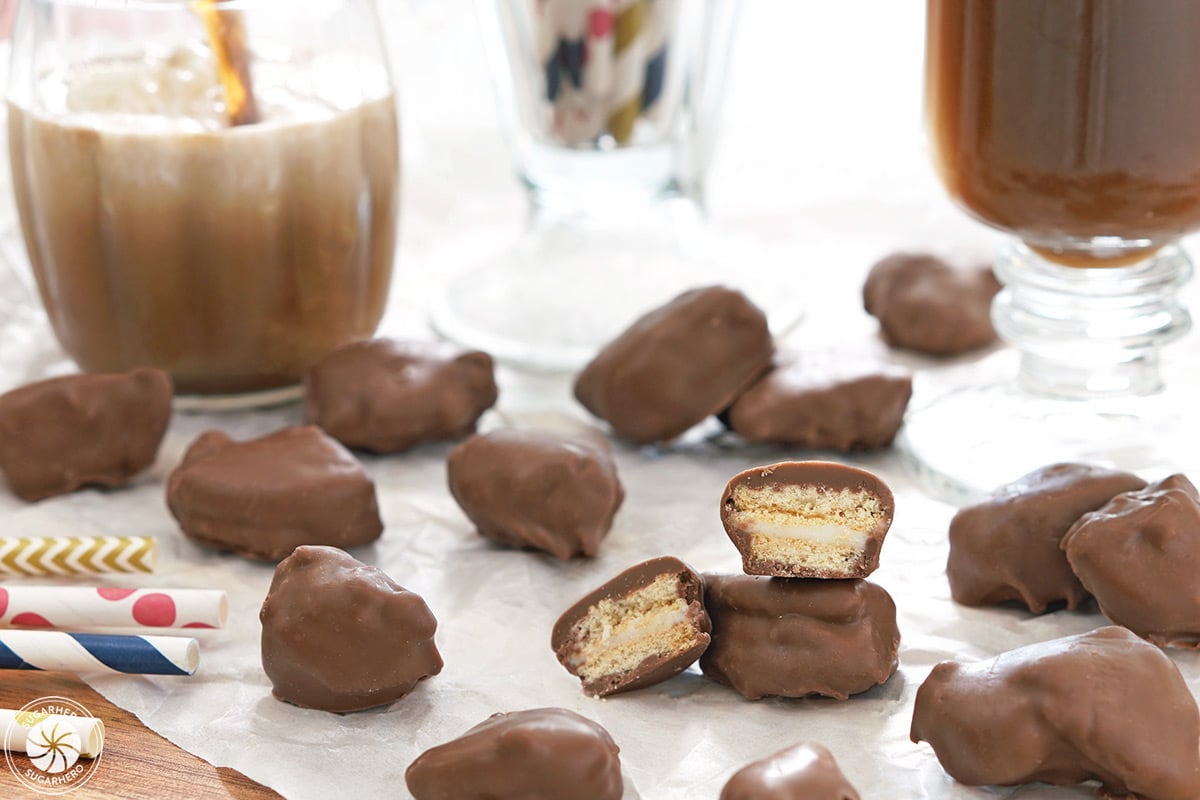 Homemade Root Beer Float Pieces scattered on white parchment, with one cut open to show the inside.