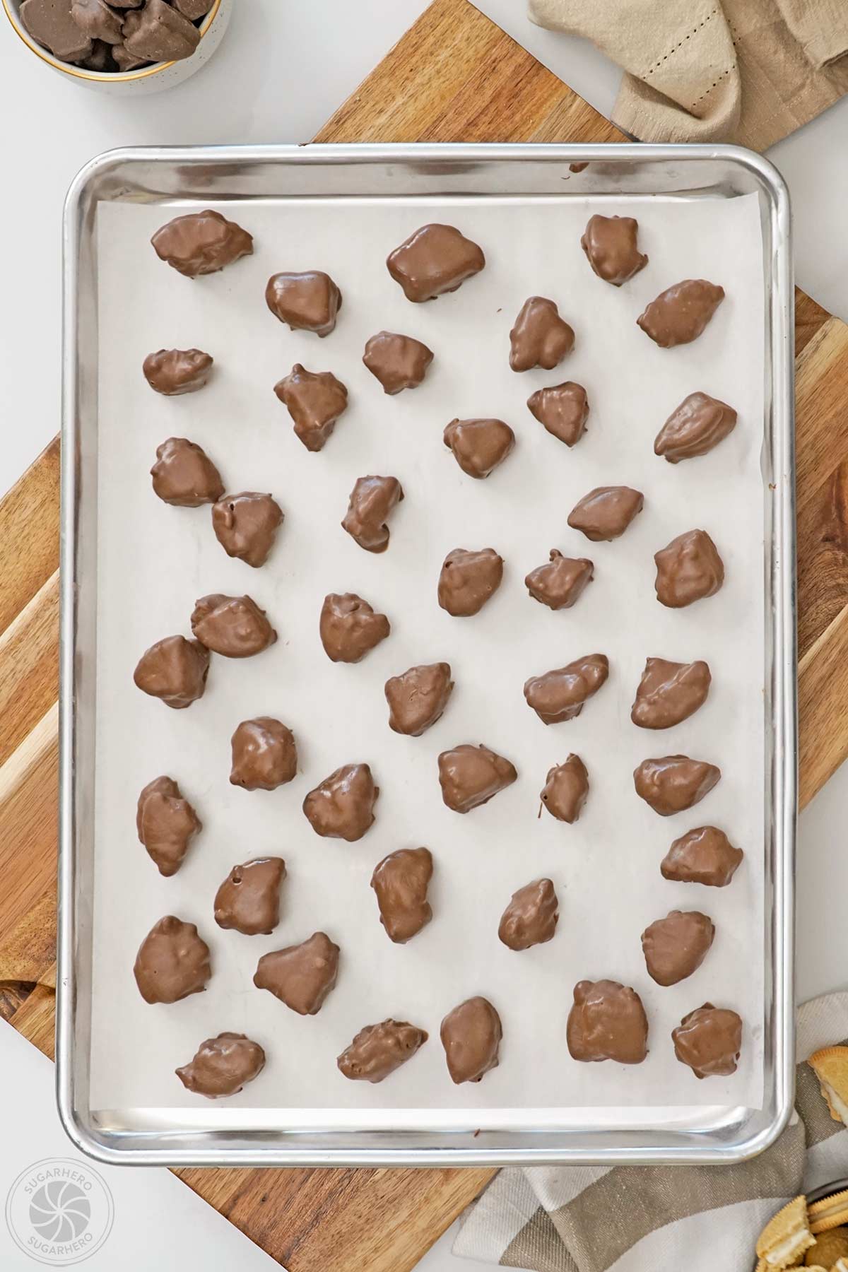 Dipped Root Beer Float Pieces on a baking sheet covered with parchment.
