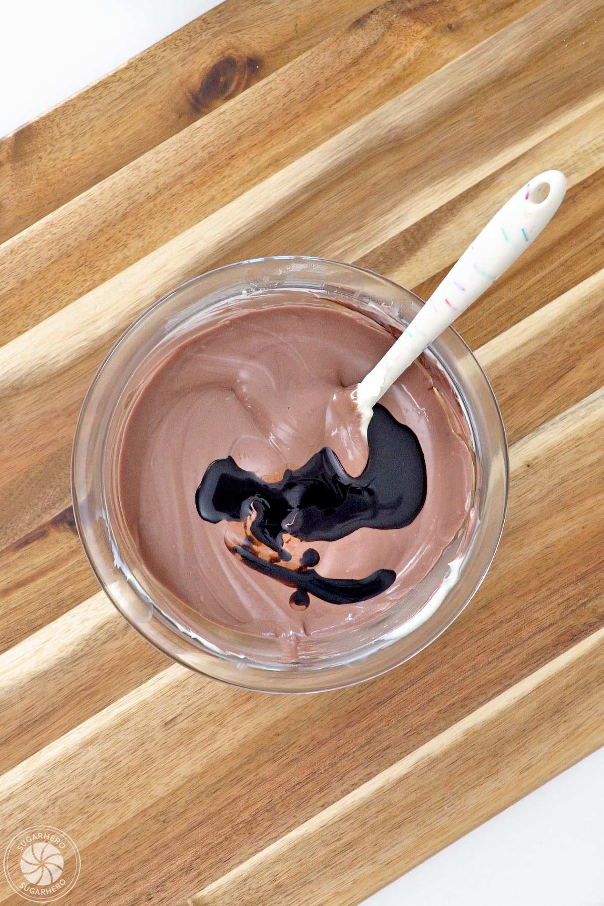 Root beer float flavoring added to a bowl of melted brown candy coating.