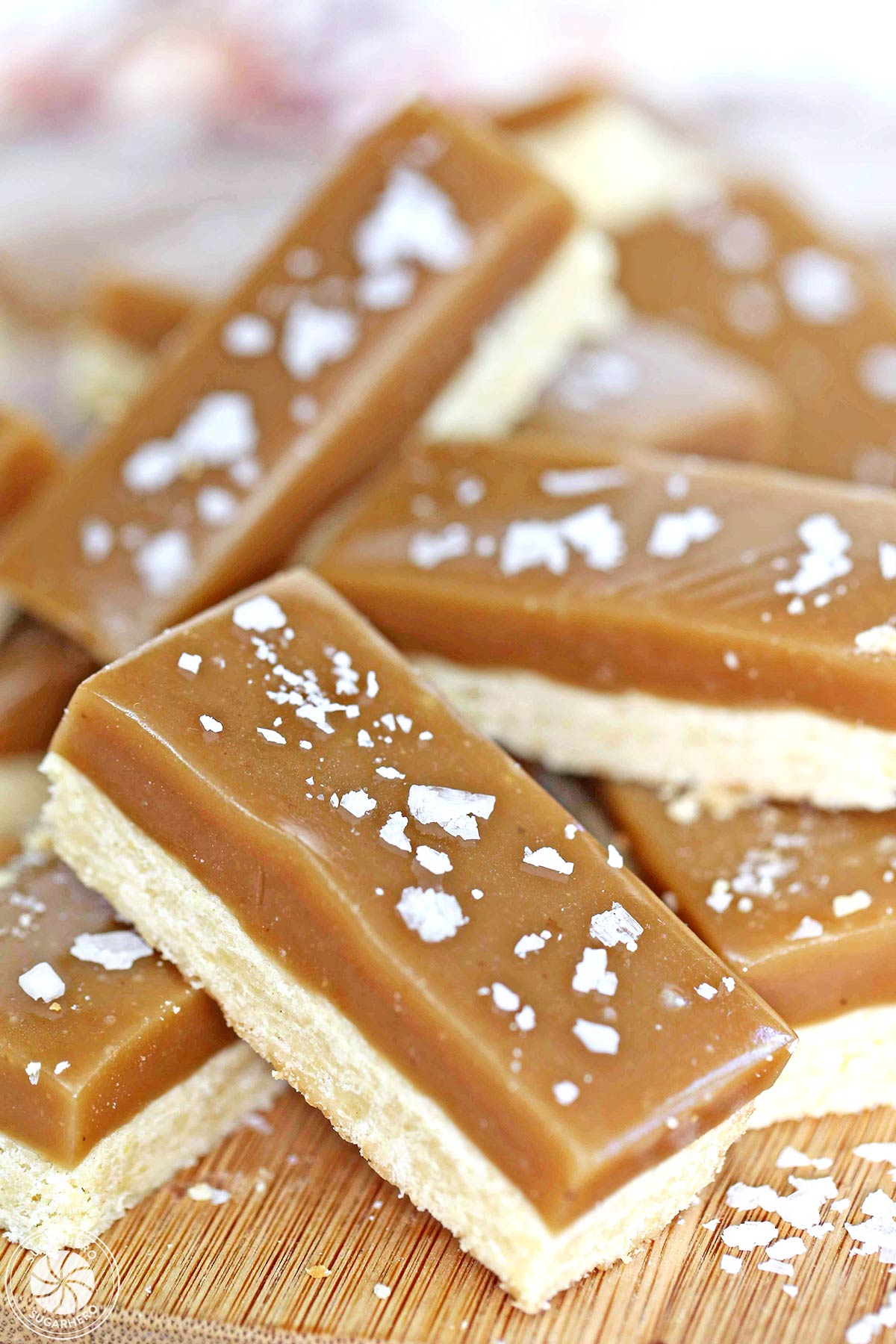 Salted Caramel Bars stacked on a wooden surface.