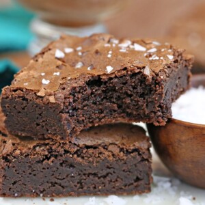 Close-up of Salted Fudge Brownies with a bite taken out of the top one.