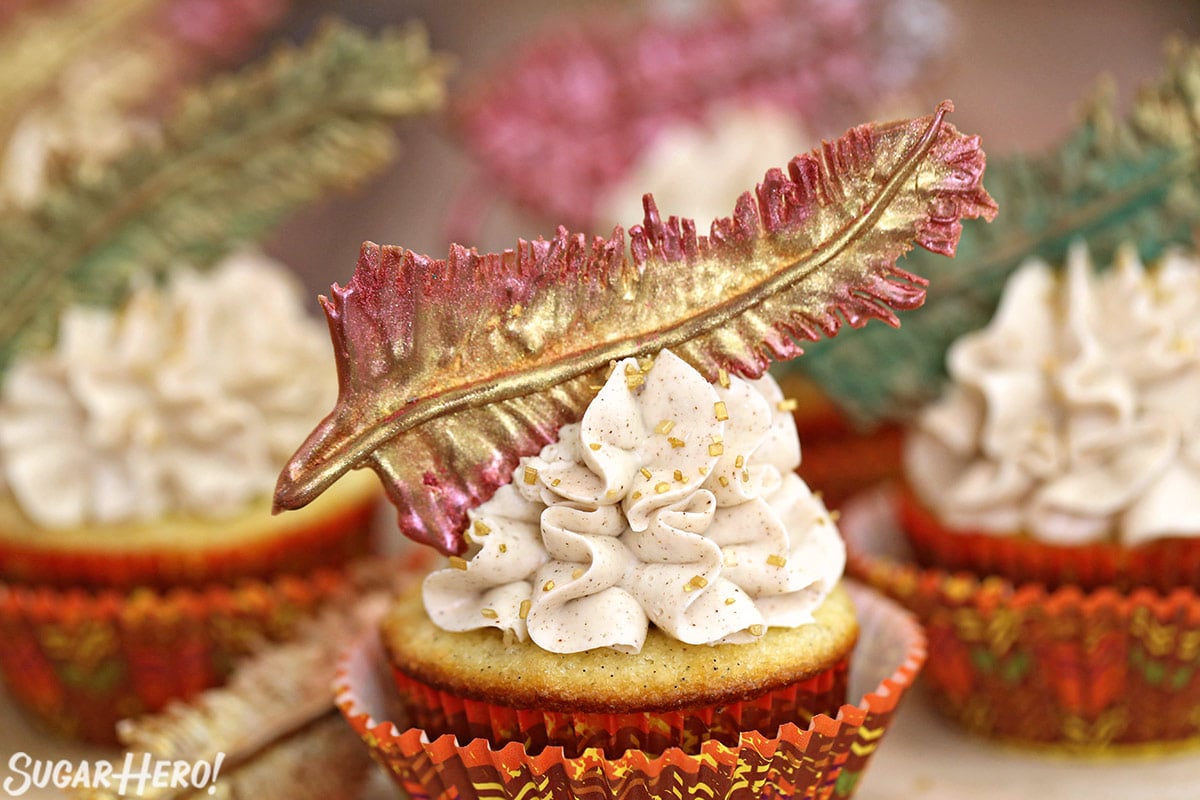Close-up of Spice Cupcake with cinnamon buttercream and a chocolate feather on top.