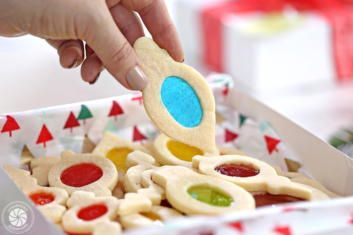 Hand holding up a Stained Glass Cookie with a blue center.