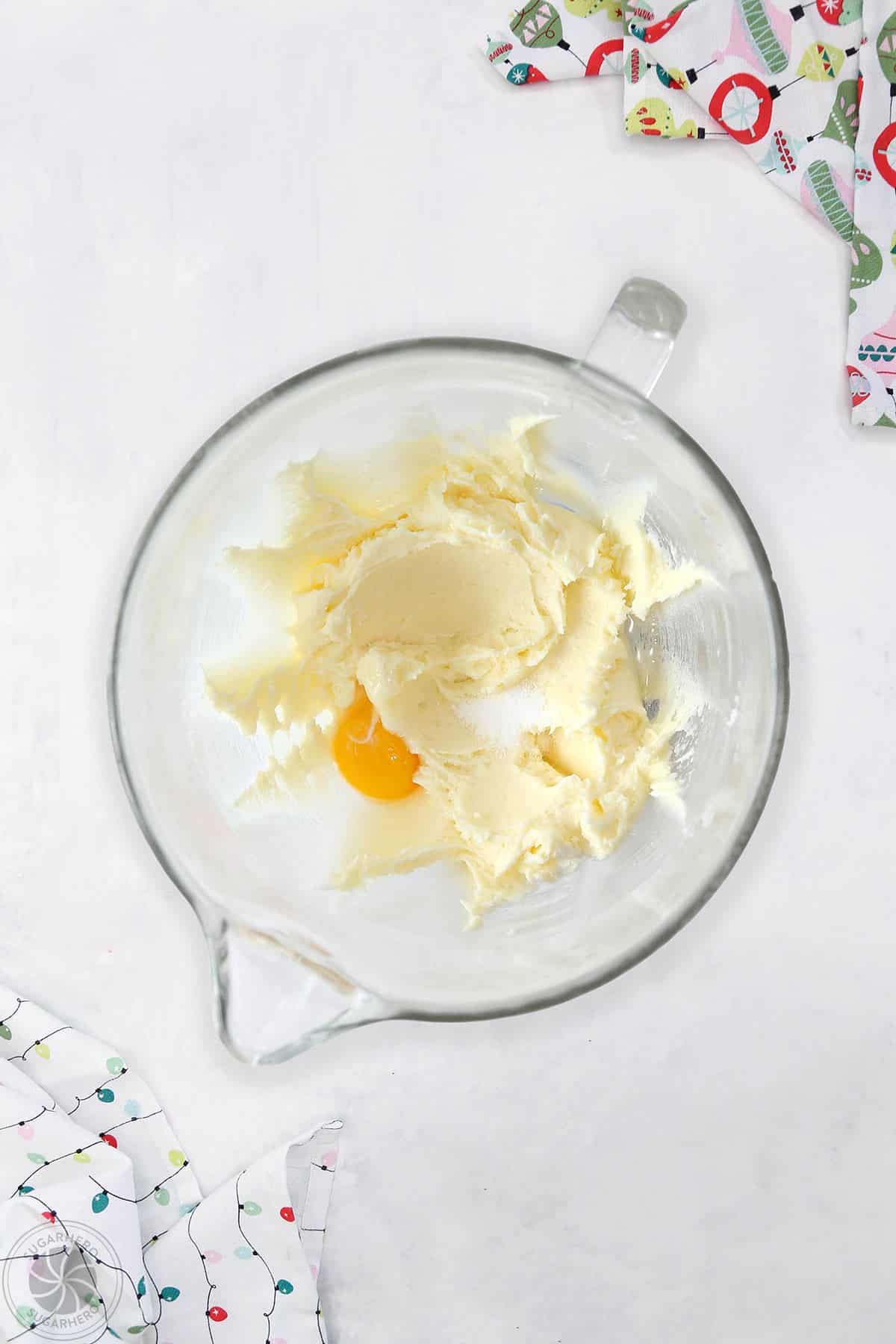 Egg, extracts and salt being added to the batter for Stained Glass Cookies.