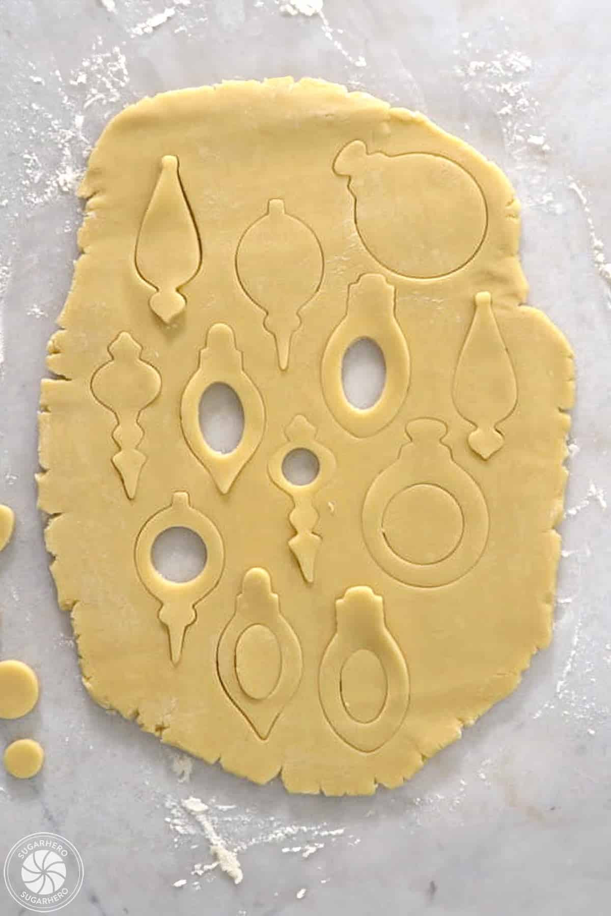 Rolled cookie dough with cut out shapes.