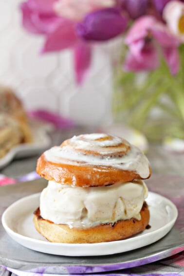 Close up of a Cinnamon Roll Ice Cream Sandwich on a small white plate.