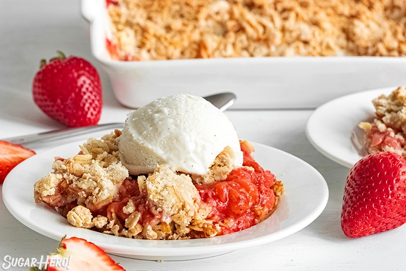 Scoop of Strawberry Crisp with vanilla ice cream on top.