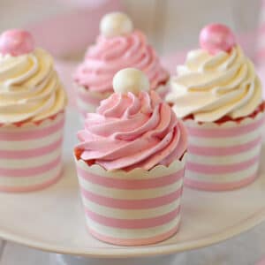 4 Strawberry Cupcakes with Italian Meringue Buttercream on a white cake plate.