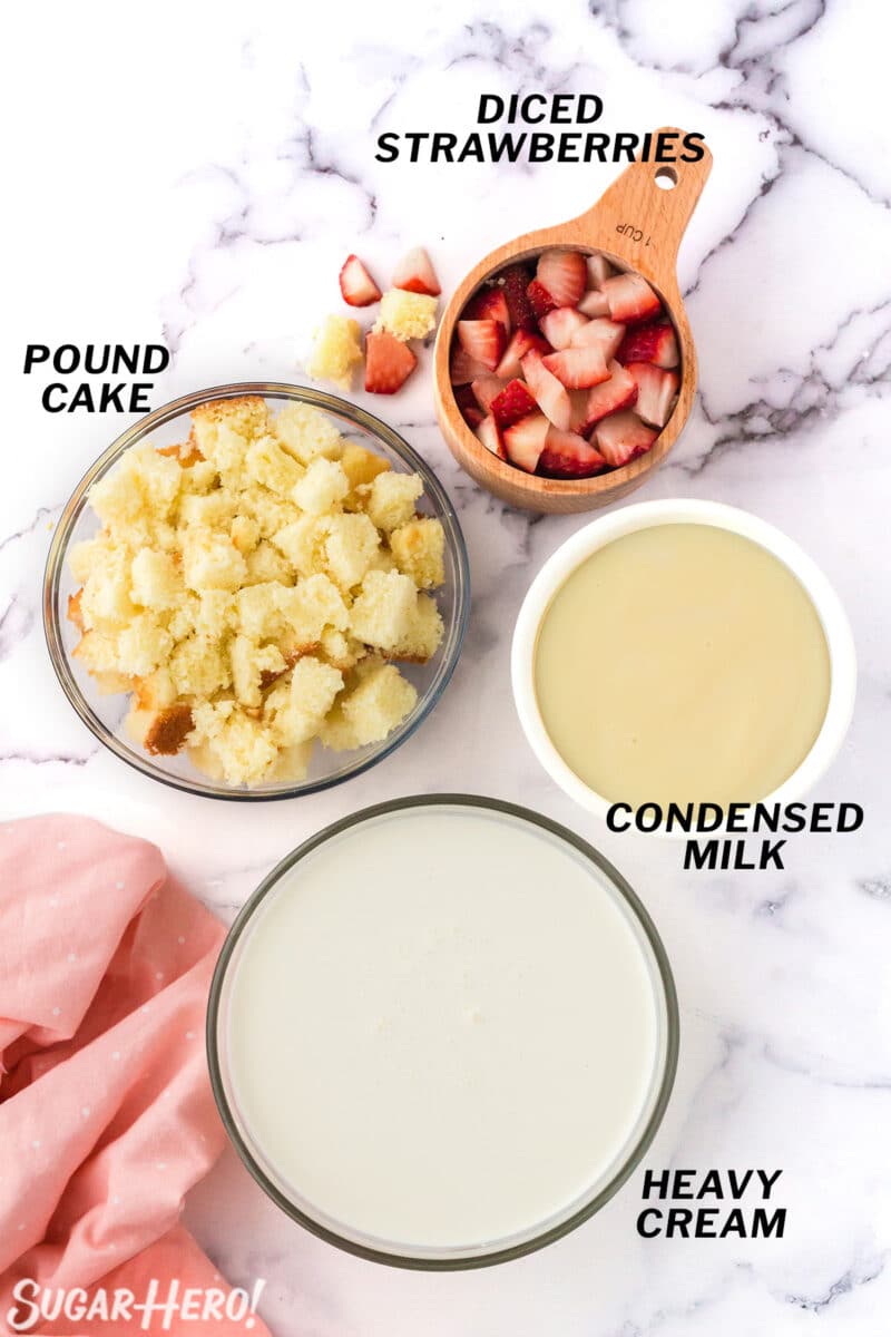 Portioned ingredients for No-Churn Strawberry Shortcake Ice Cream on a marble countertop.