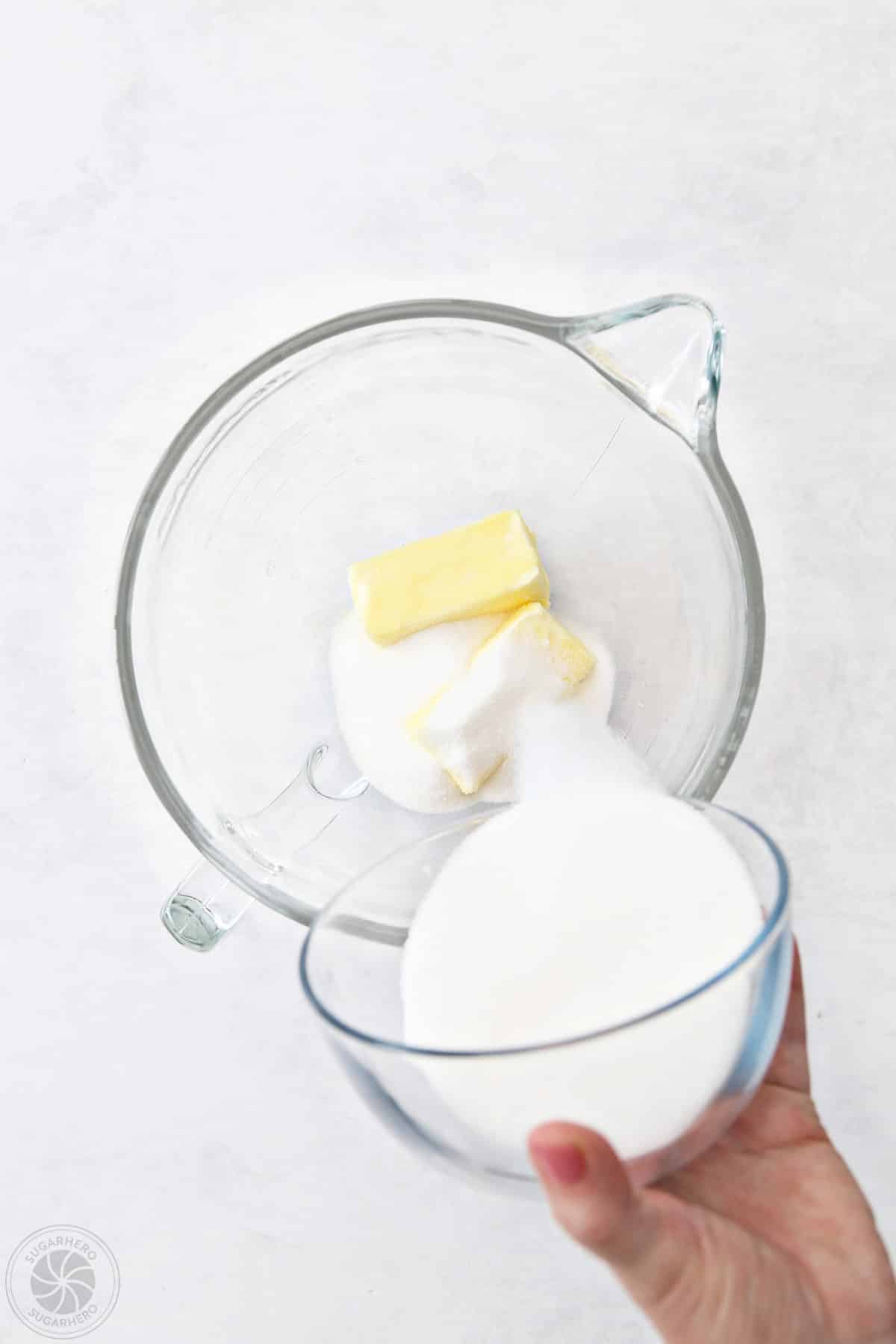 A mixing bowl with sugar and butter for sugar cookies.